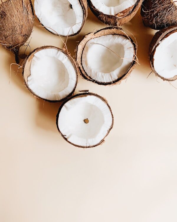 Whole coconuts on a white surface